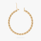 a large gold slim twisted hoop earring unhinged 