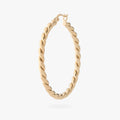 a large gold slim twisted hoop earring 