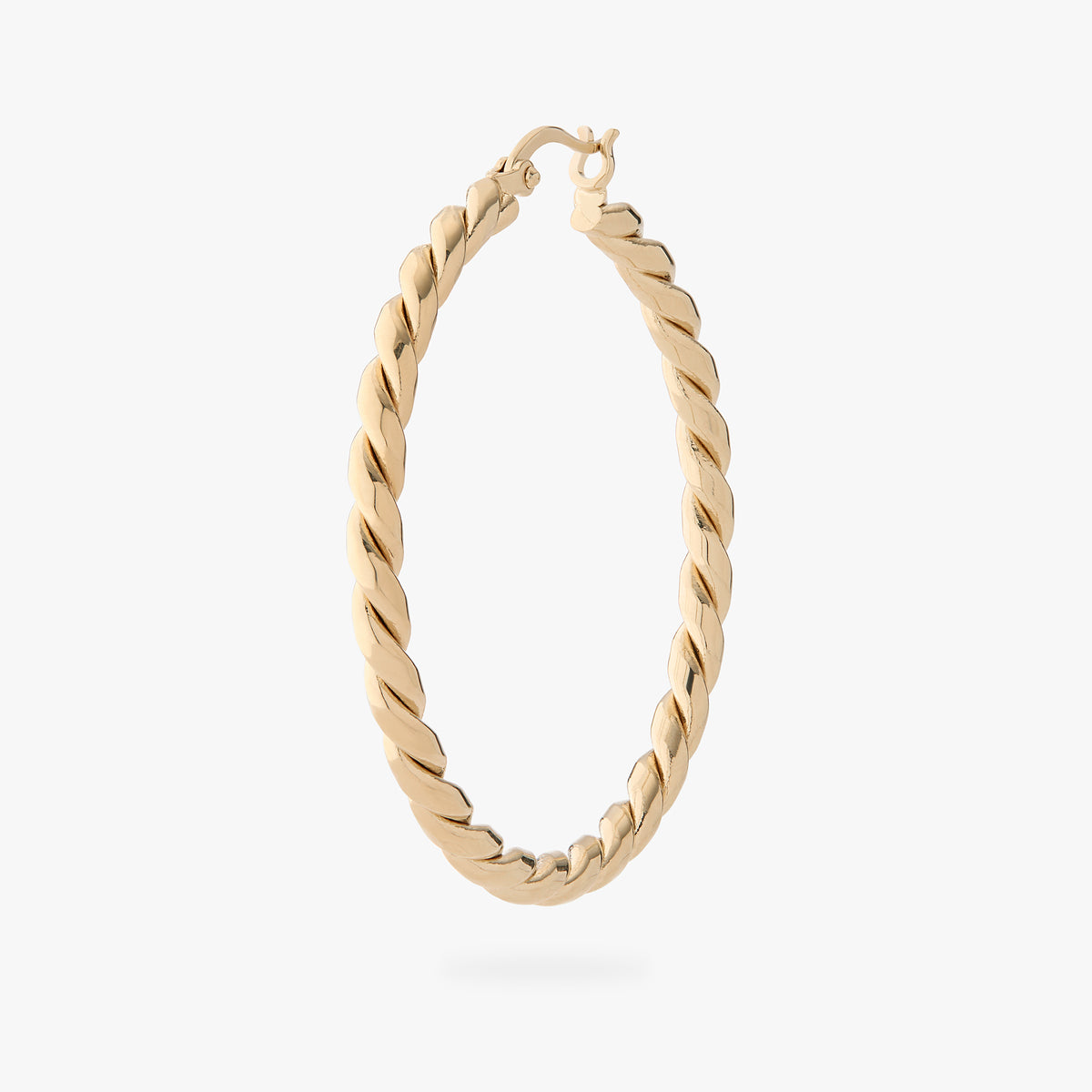 a large gold slim twisted hoop earring 