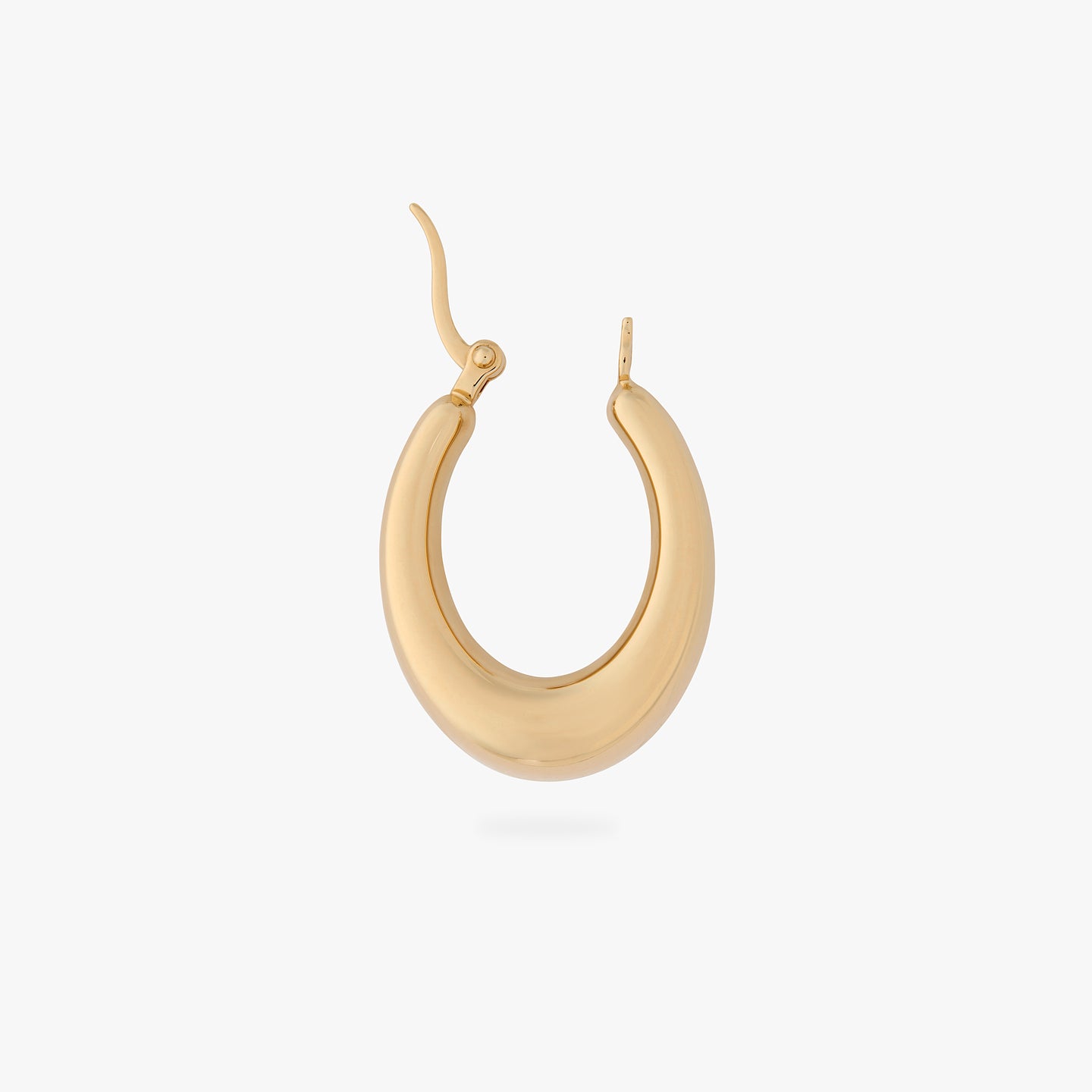 an oval shaped hoop earring in gold unhinged color:null|gold