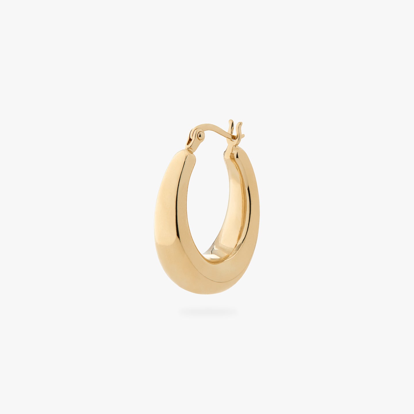 an oval shaped hoop earring in gold color:null|gold
