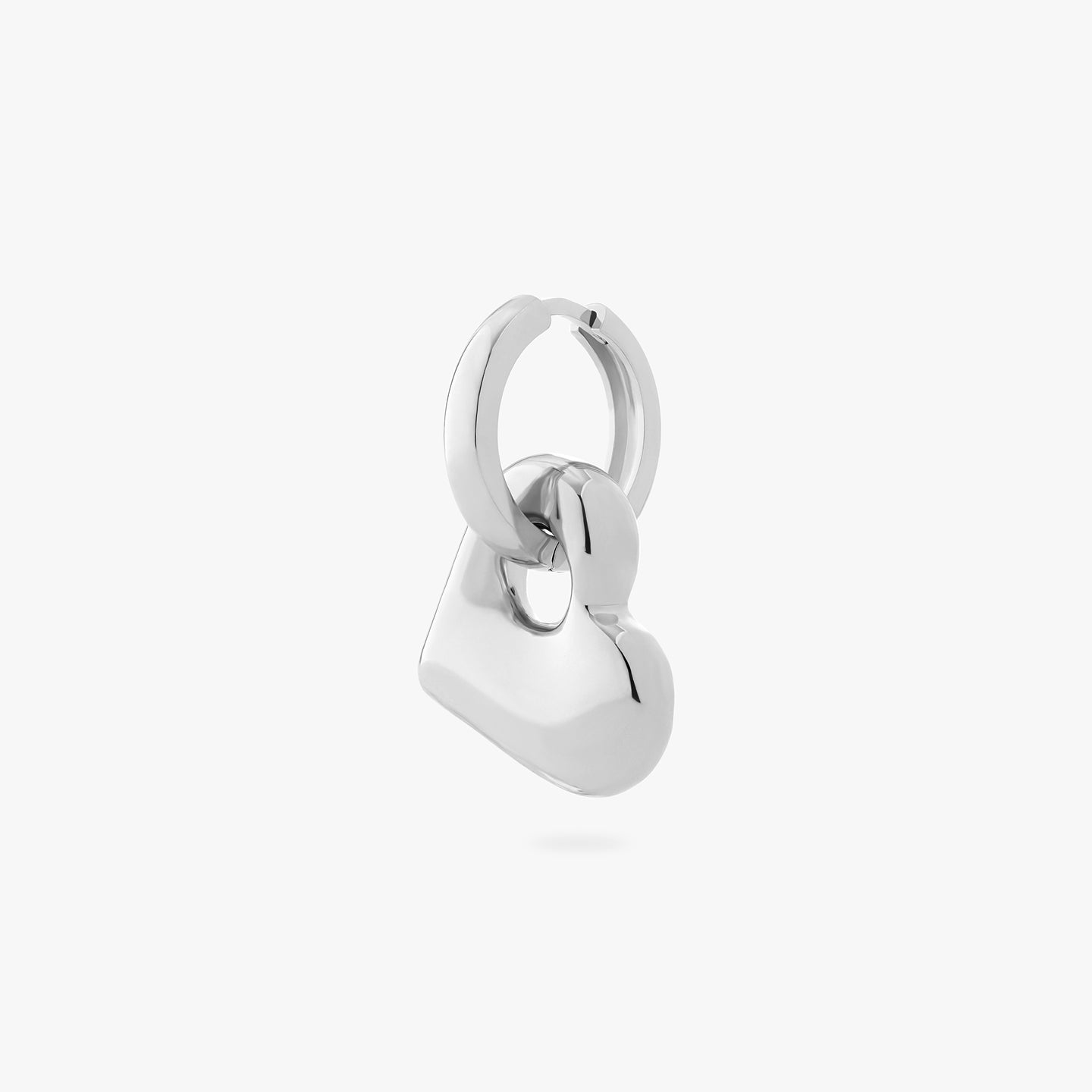 a chunky silver hoop that has a silver puffy heart charm on it color:null|silver