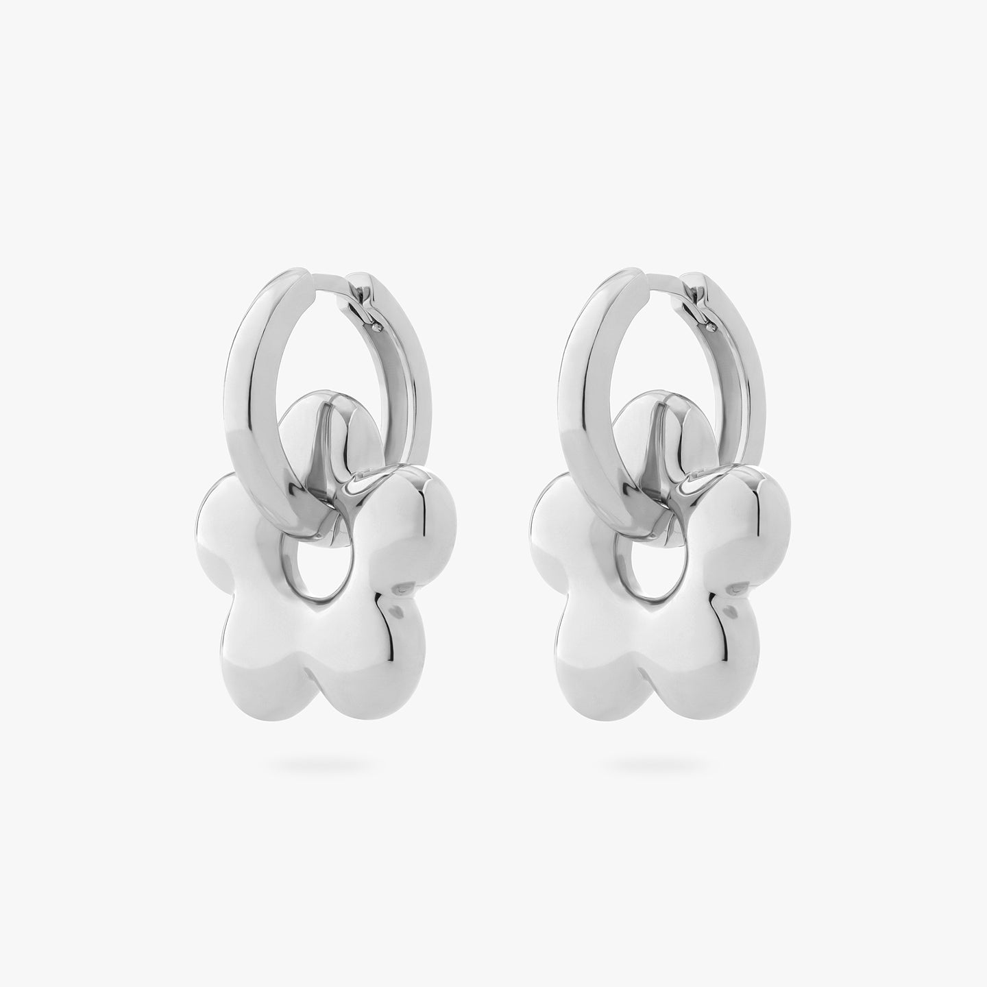 a pair of silver chunky hoops with silver charms in the shape of puffy daisies on them [hover] color:null|silver