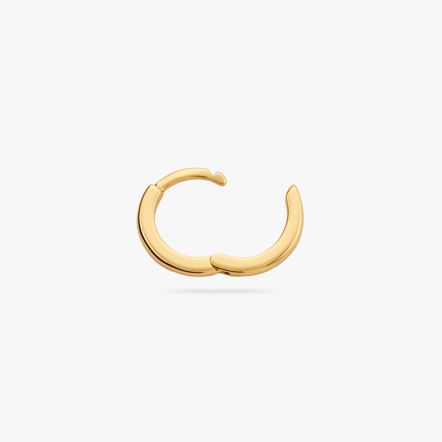 This is a small gold huggie with square edges and its clasp undone color:null|gold