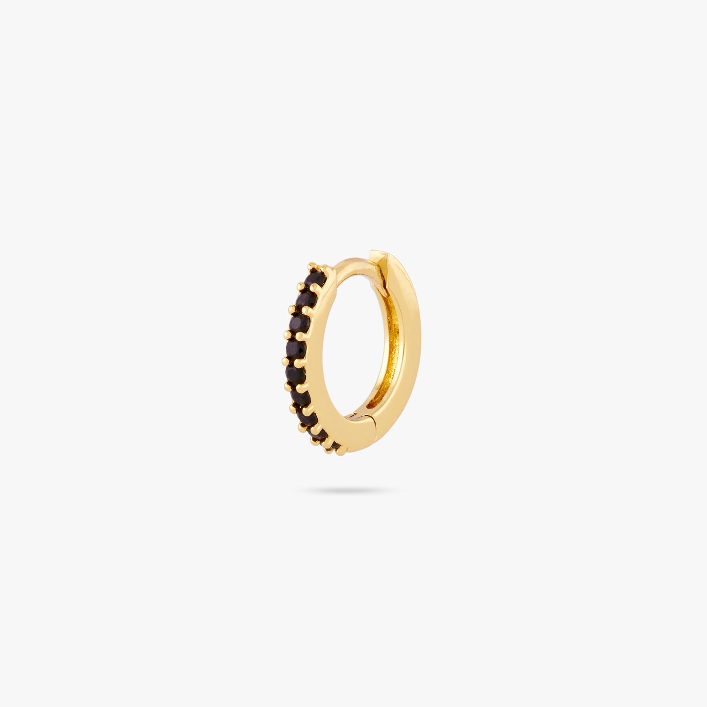 A mini gold huggie lined with black cz gems on the front color:null|gold/black