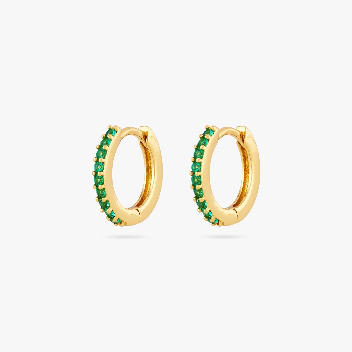 A pair of mini gold huggies lined with green cz gems on the front [pair] color:null|gold/green