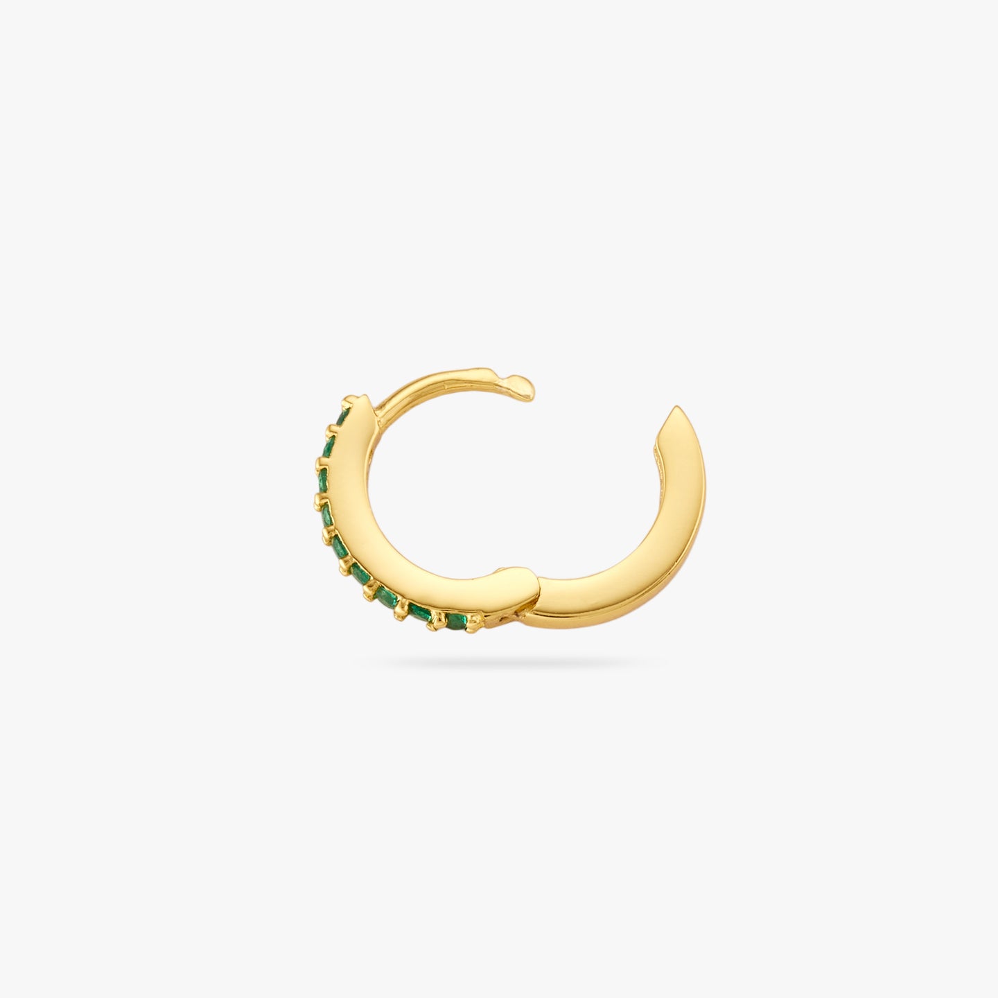 A mini gold huggie lined with green cz gems on the front and the clasp undone color:null|gold/green