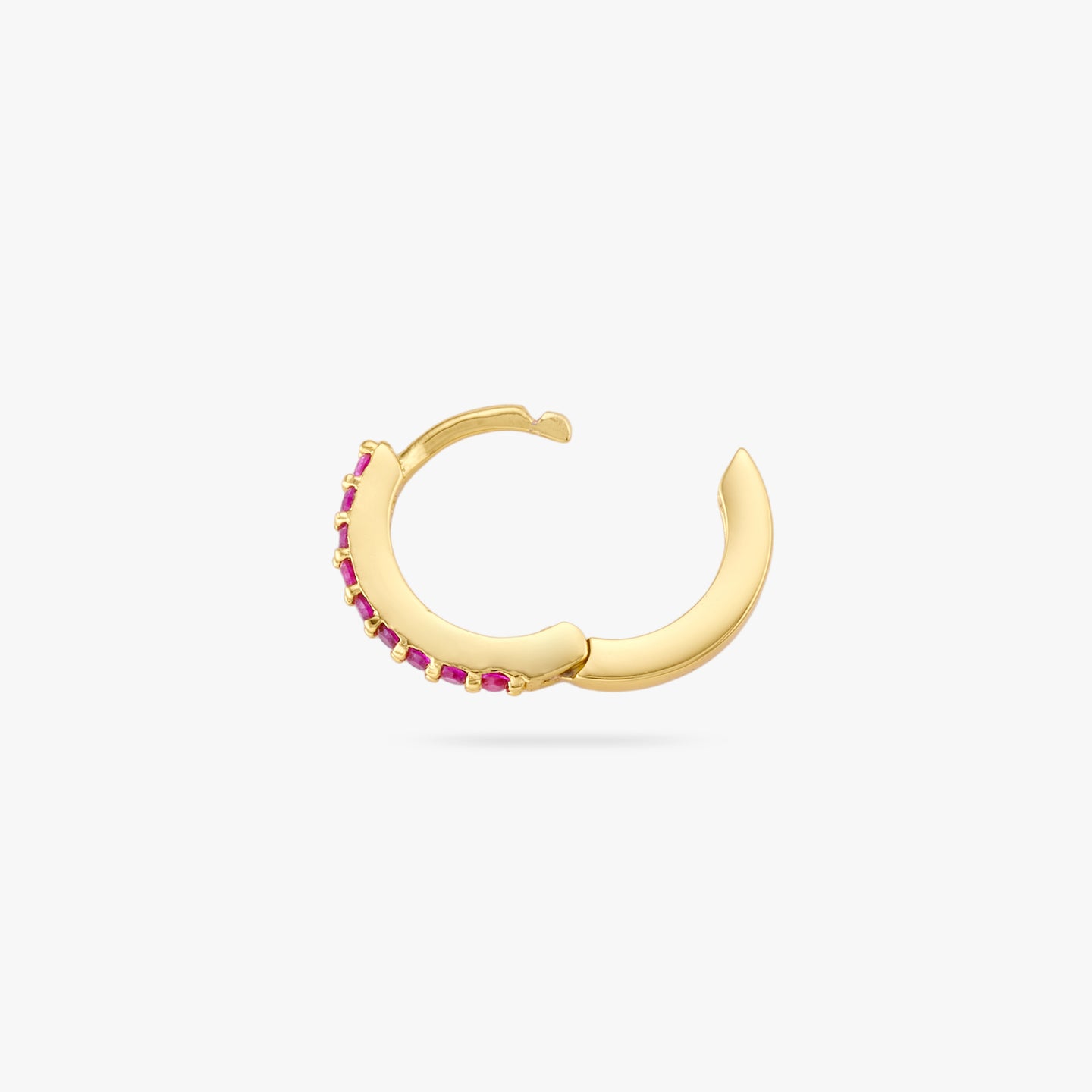 A mini gold huggie lined with pink cz gems on the front and the clasp is undone color:null|gold/pink