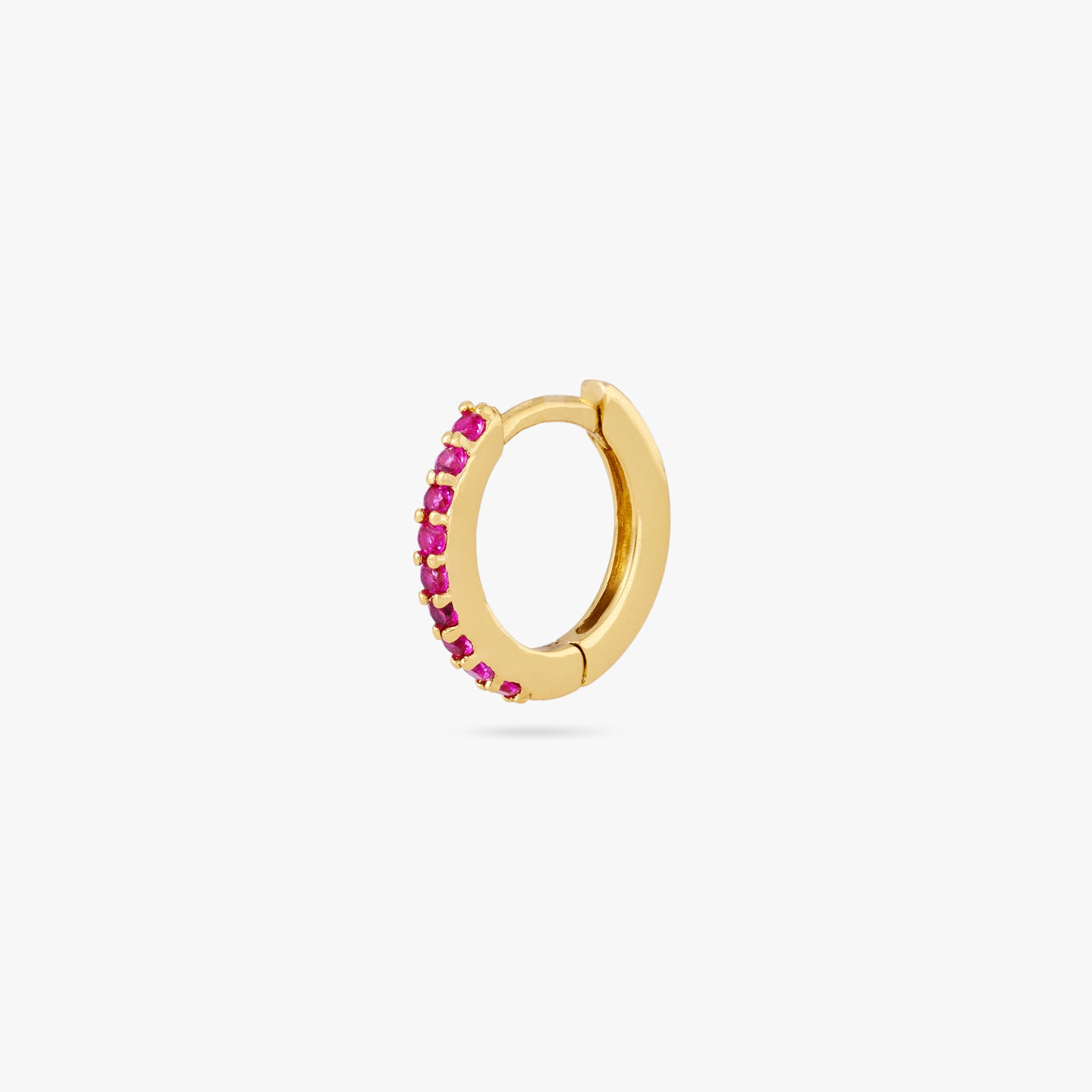 A mini gold huggie lined with pink cz gems on the front color:null|gold/pink
