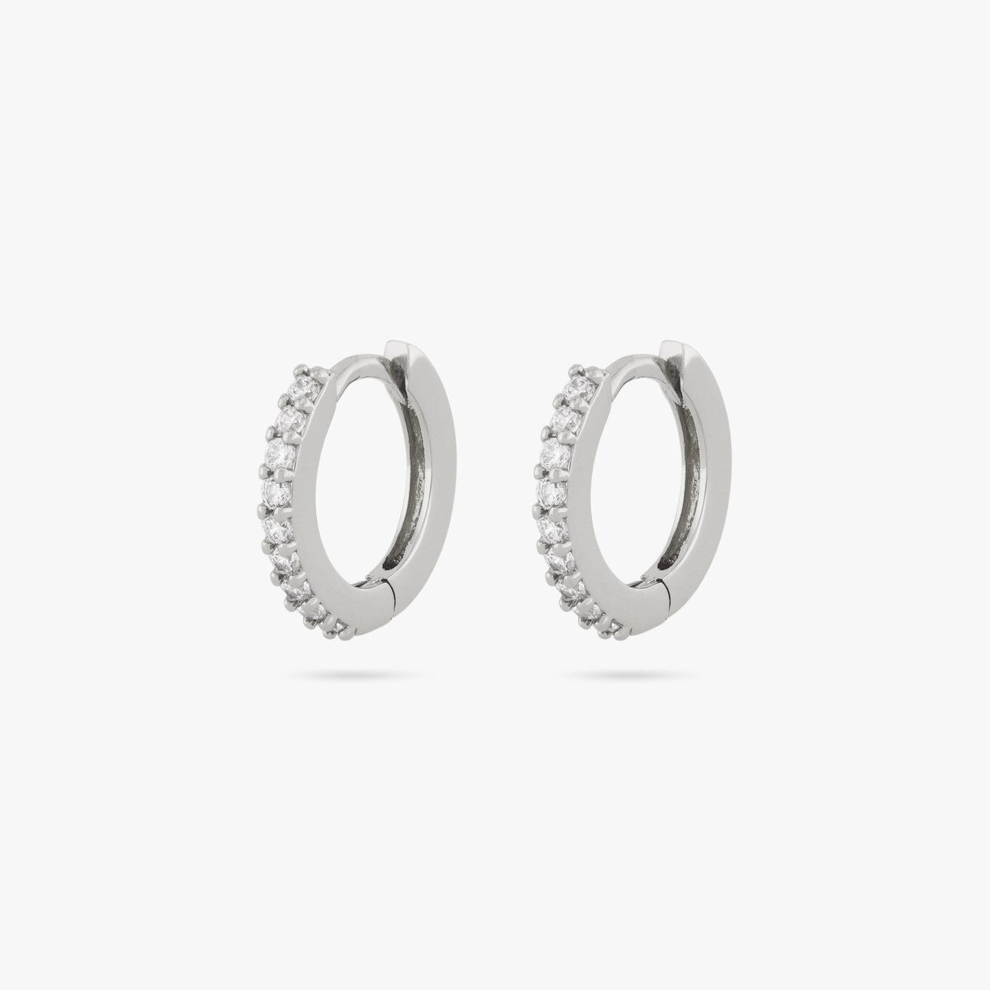 A pair of mini silver huggies lined with clear cz gems on the front [pair] color:null|silver/clear
