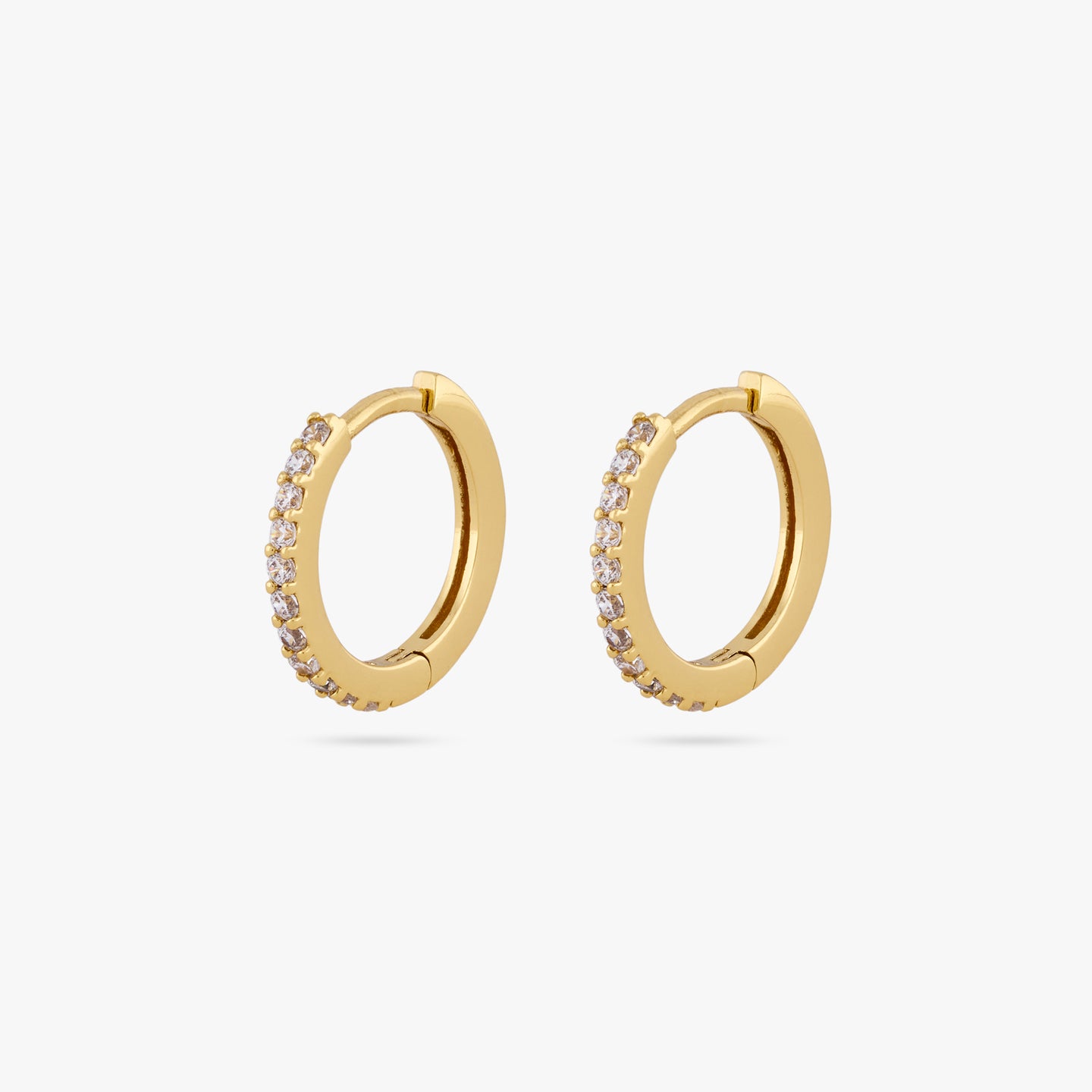 This is a pair of small gold huggies measuring 13mm that features clear cz gems along the front [pair] color:null|gold/clear