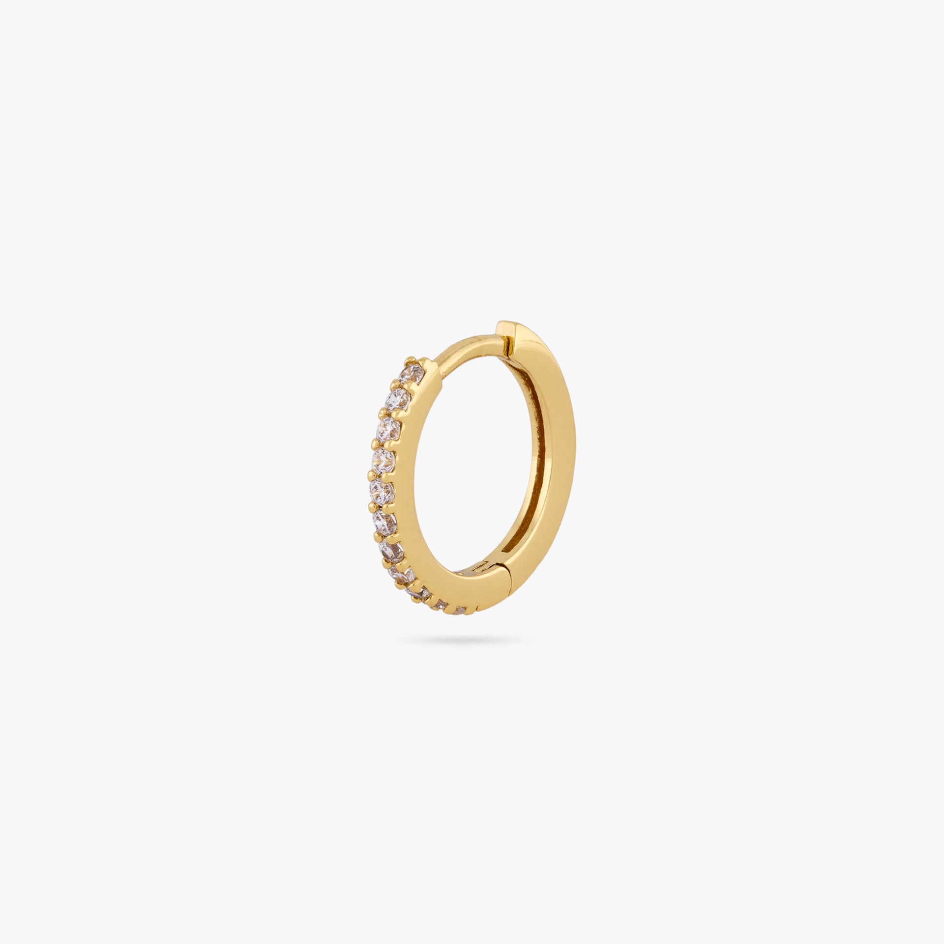 This is a small gold huggie measuring 13mm that features clear cz gems along the front color:null|gold/clear