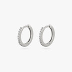 Pair of silver huggies with clear CZs lining the front. [pair] color:null|silver/clear