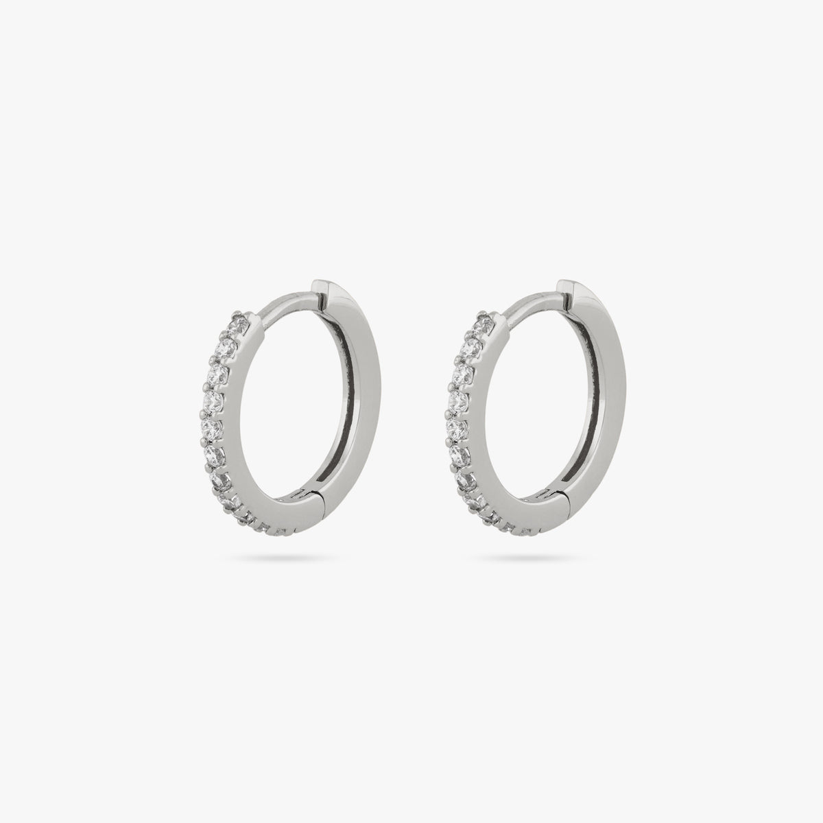 Pair of silver huggies with clear CZs lining the front. [pair] color:null|silver/clear