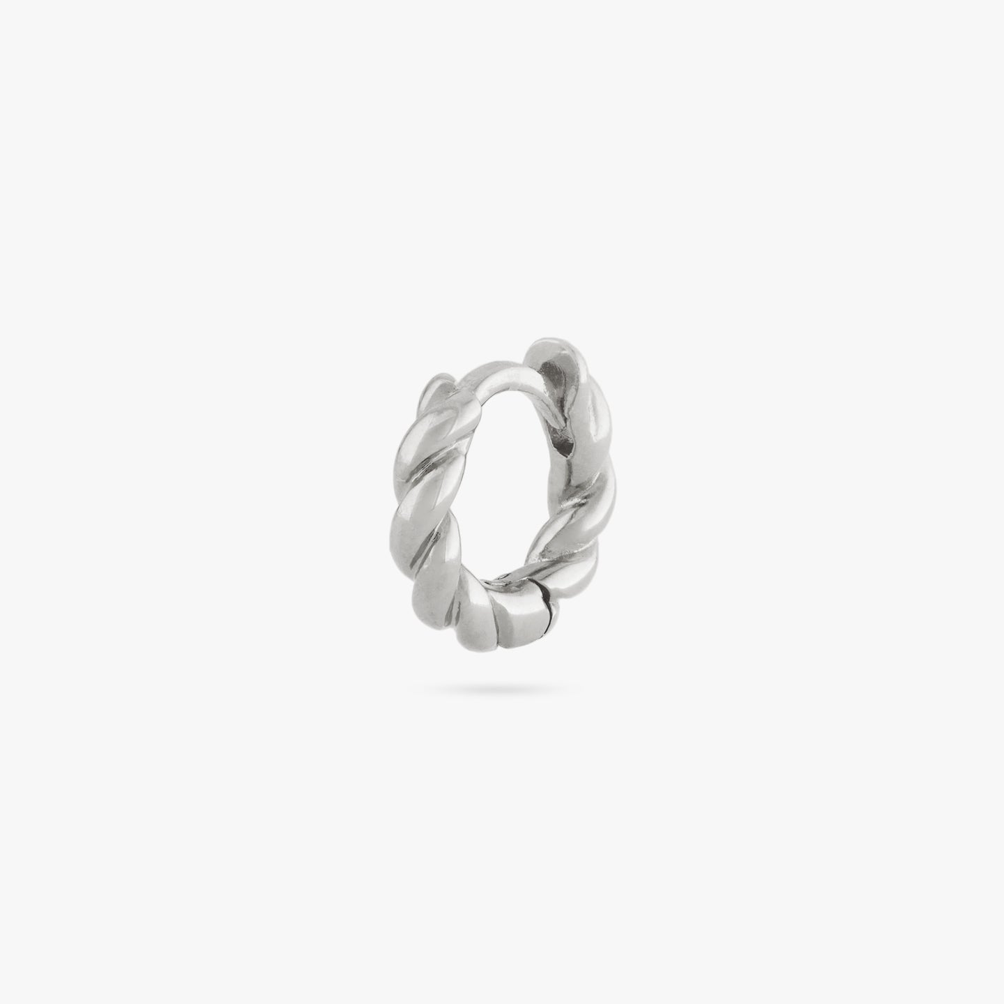 This is a small silver huggie with a twisted detail color:null|silver