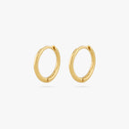 pair of small slim gold huggies. [pair] color:null|gold