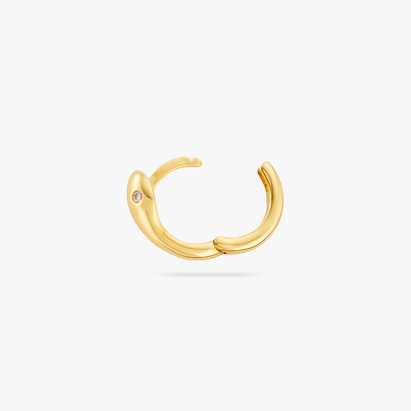 This is a gold serpent shaped huggie earring with a clear CZ eye and its clasp undone color:null|gold