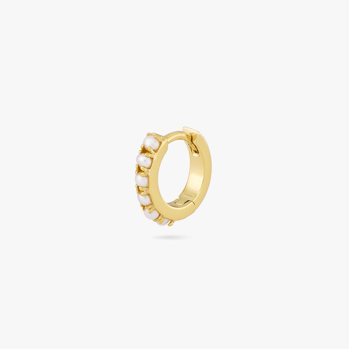 This is a small gold huggie that has small pearls lining the front of it color:null|gold