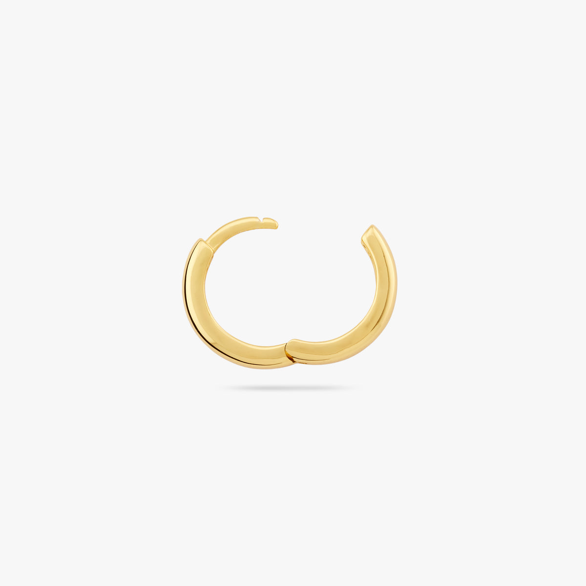 A small bulky and chunky shaped gold huggie and the clasp is undone color:null|gold