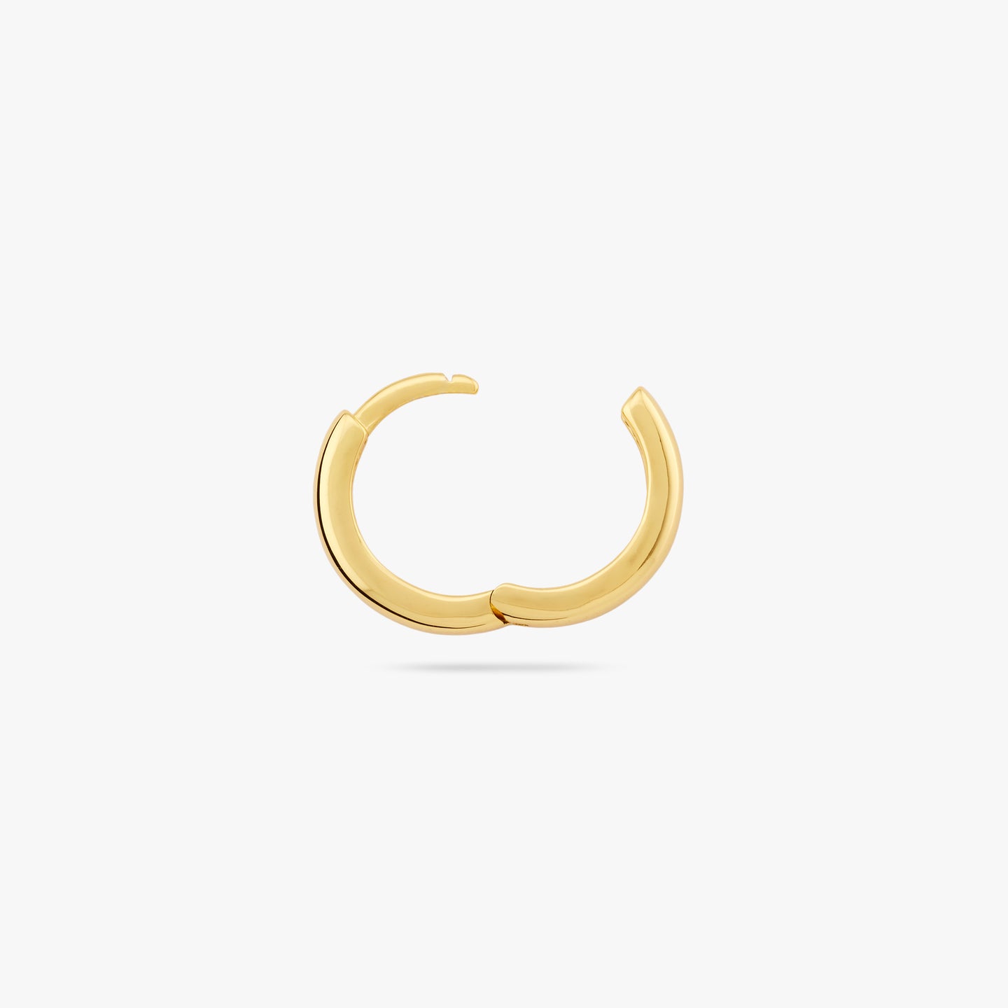 A small bulky and chunky shaped gold huggie and the clasp is undone color:null|gold