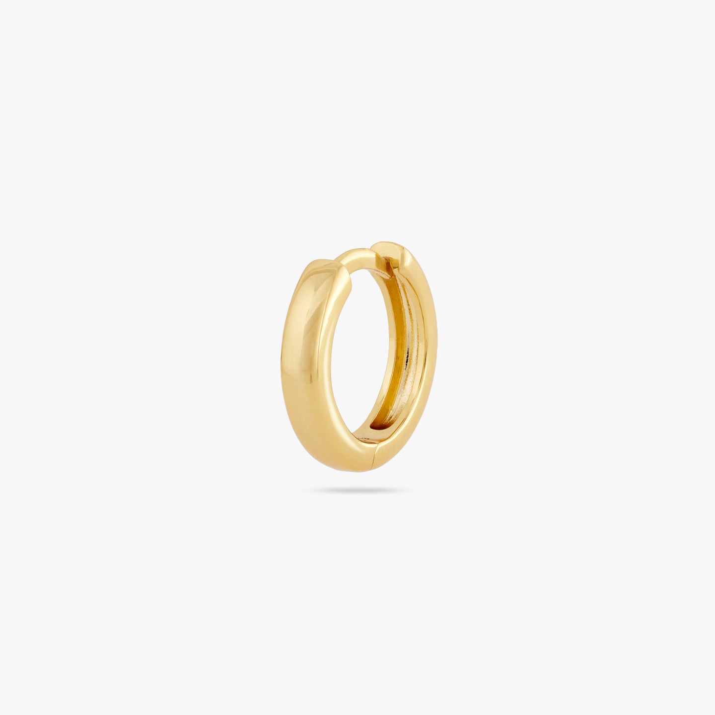 A small bulky and chunky shaped gold huggie color:null|gold