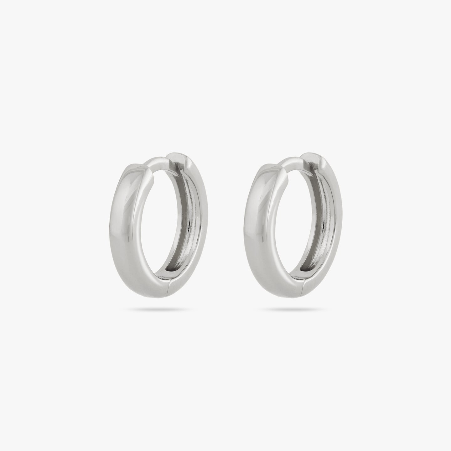 A pair of small bulky and chunky shaped silver huggies [pair] color:null|silver