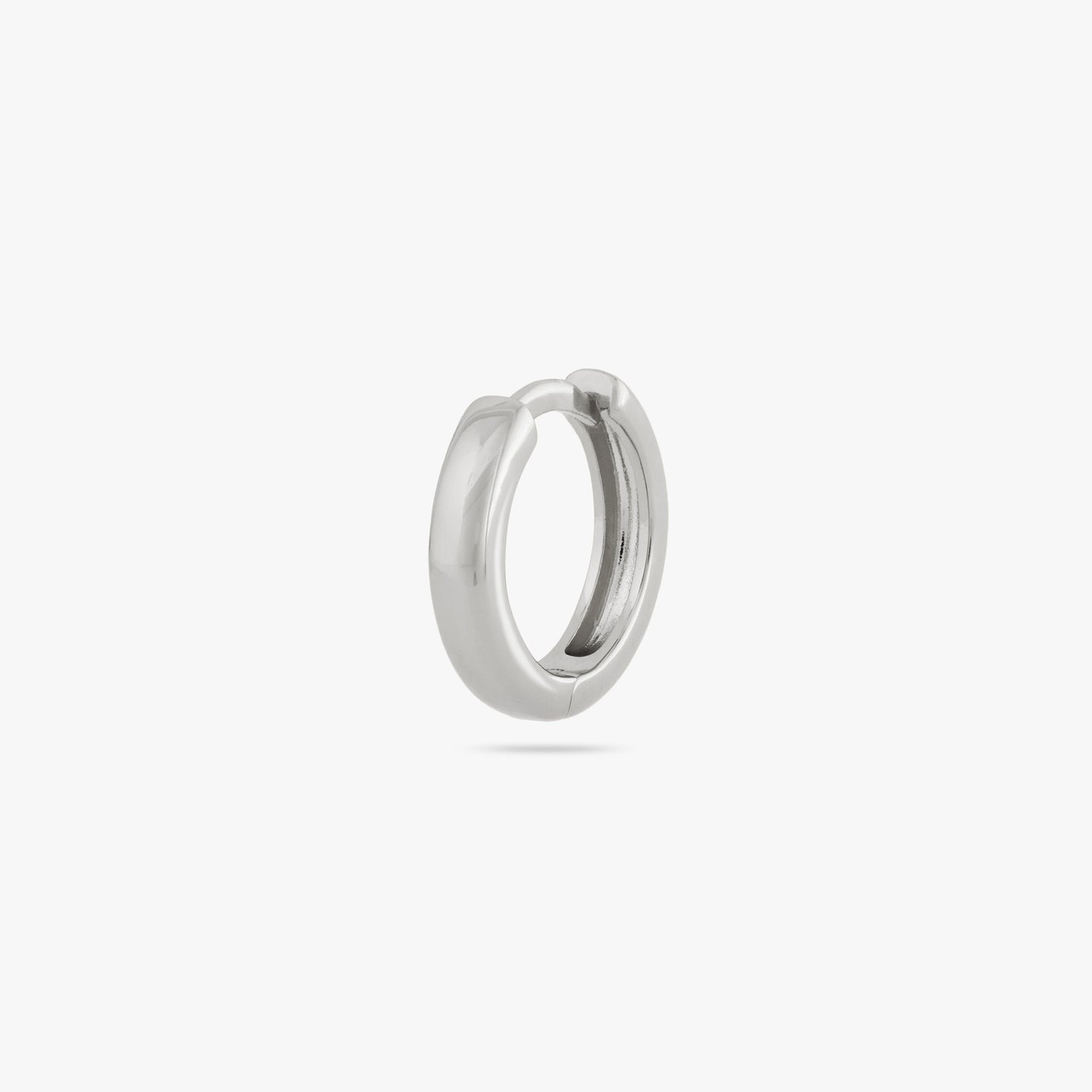 A small bulky and chunky shaped silver huggie color:null|silver