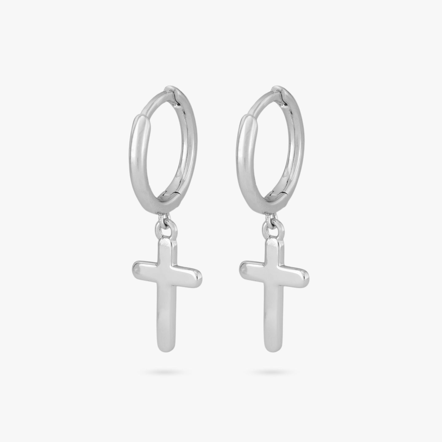 This is a pair of small silver huggies with cross charm dangles [pair] color:null|silver