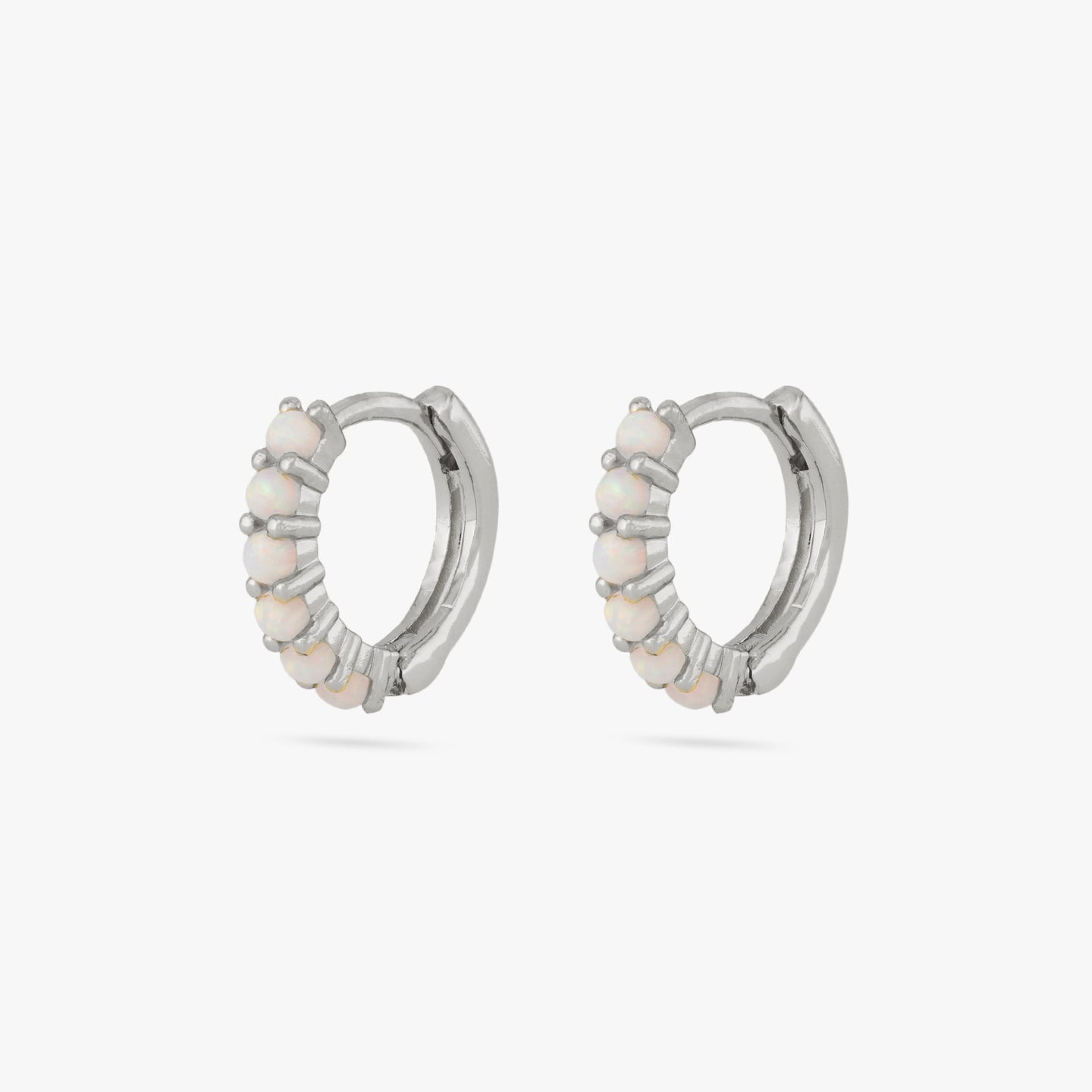This is a pair of silver huggies with large opal pavé [pair] color:null|silver/opal