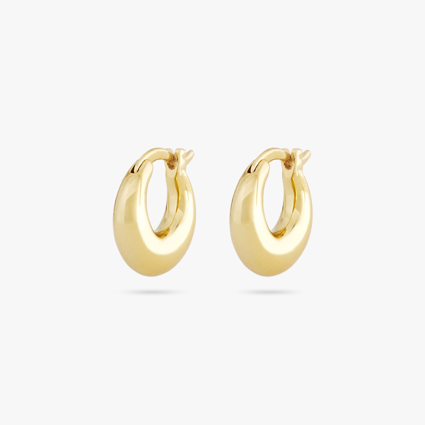 This is a pair of small gold huggies in the shape of crescents [pair] color:null|gold