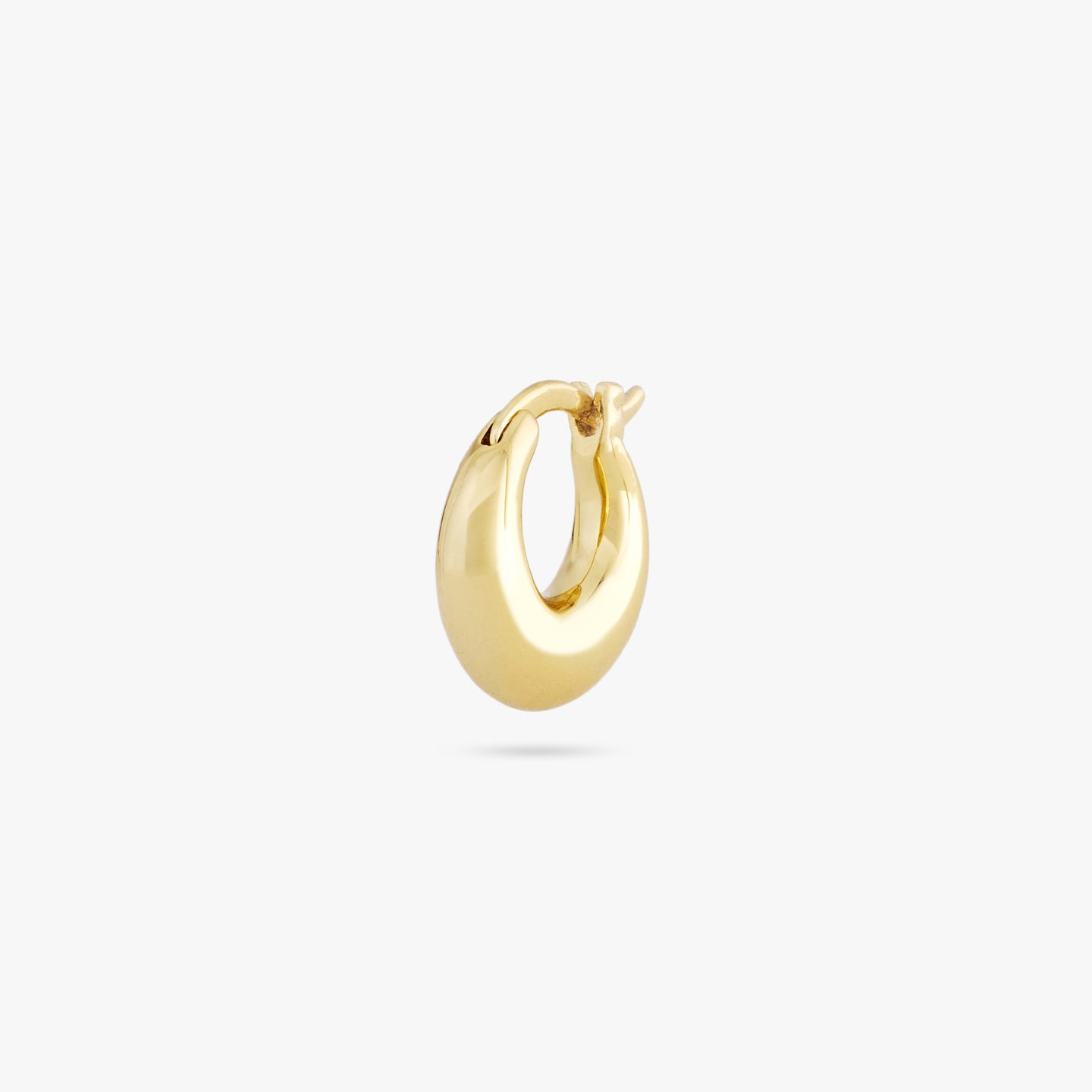 This is a small gold huggie in the shape of a crescent color:null|gold