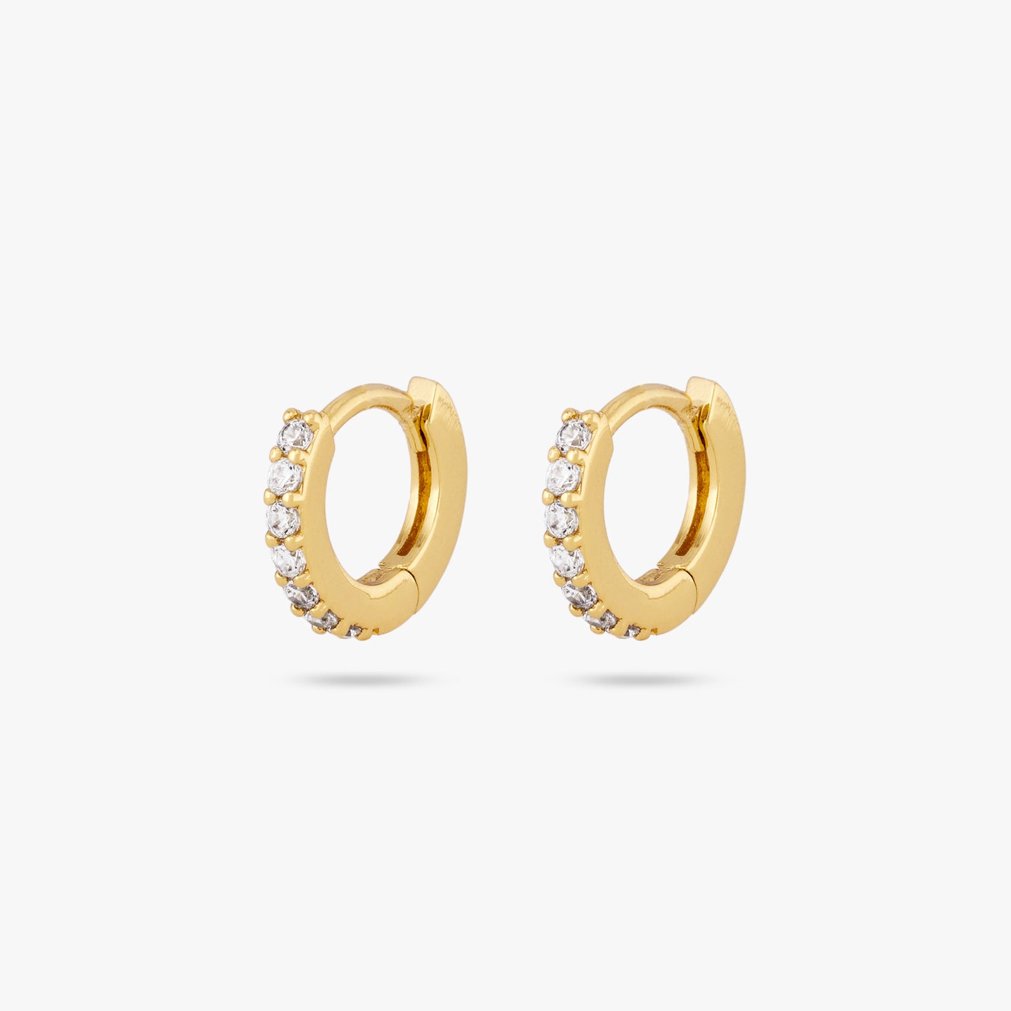 A pair of clear/gold micro pave huggies with a 6mm inner diameter [pair] color:null|gold/clear
