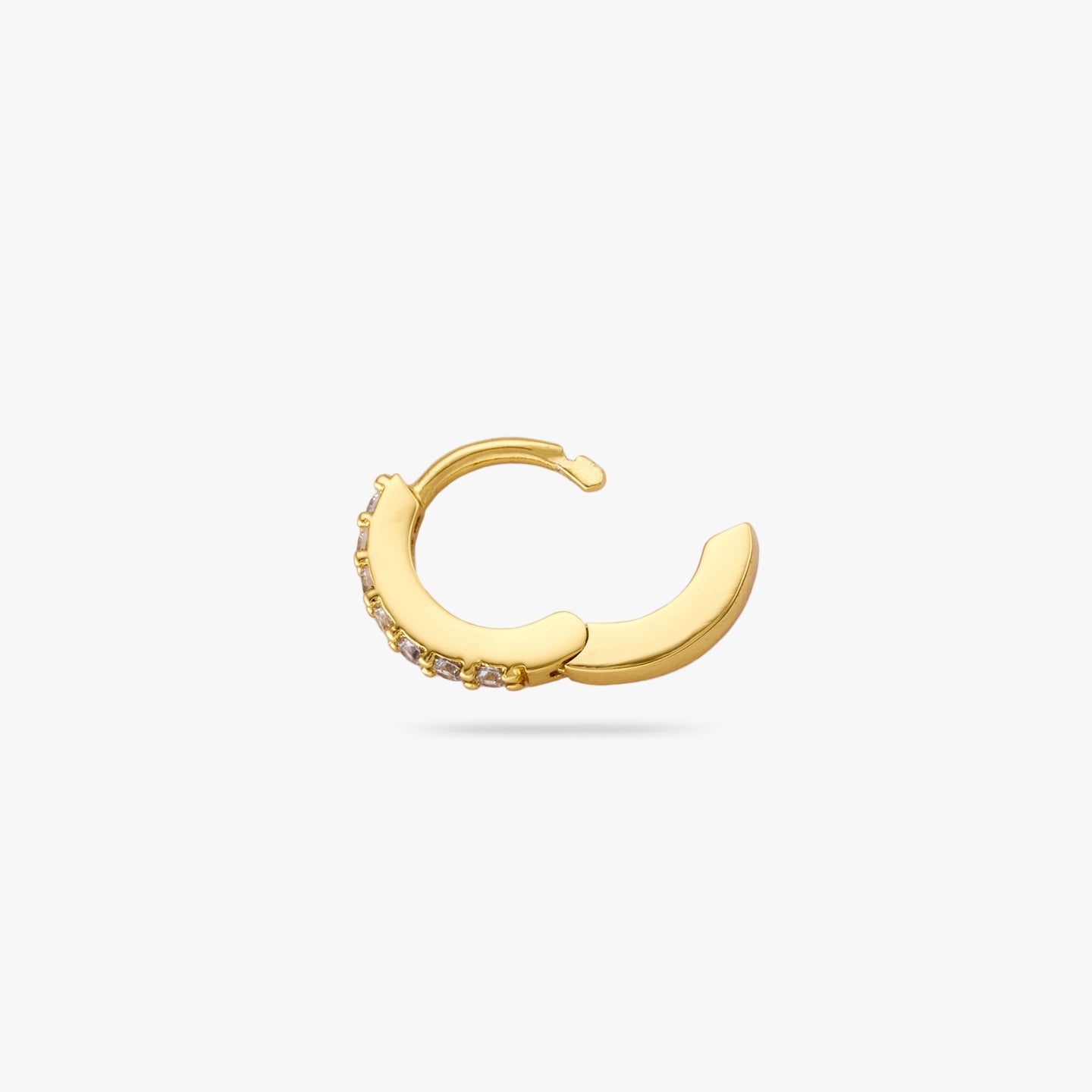 A clear/gold micro pave huggie with a 6mm inner diameter and the clasp undone color:null|gold/clear