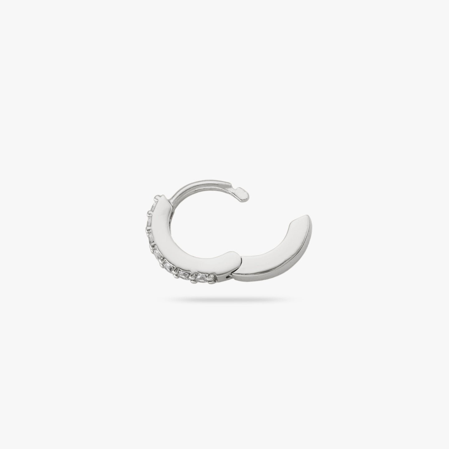 A silver/clear micro pave huggie with a 6mm inner diameter and the clasp is undone color:null|silver/clear