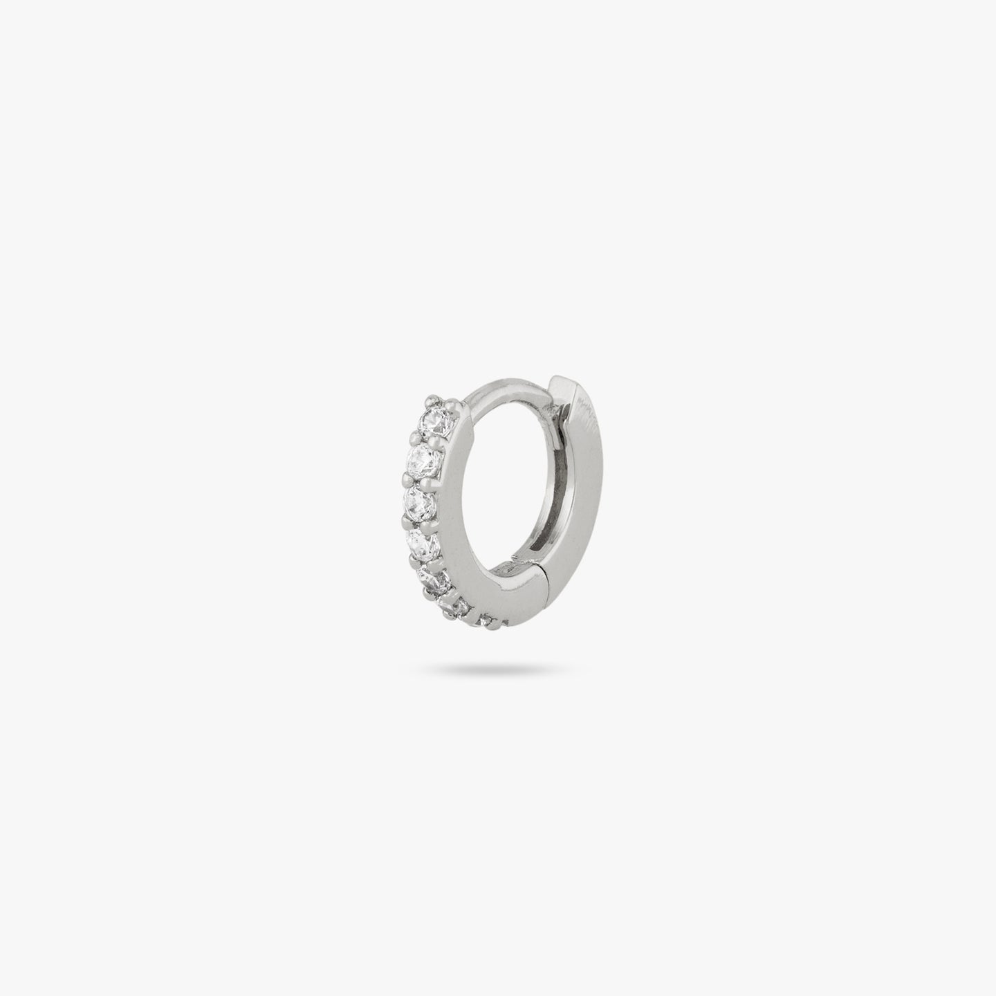 A silver/clear micro pave huggie with a 6mm inner diameter color:null|silver/clear