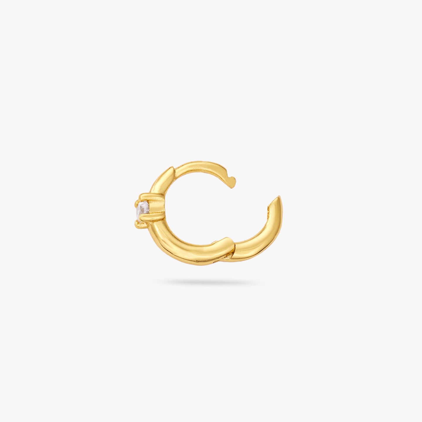 This is a small gold huggie with a clear cz detail in the center of the front and the clasp is undone color:null|gold/clear
