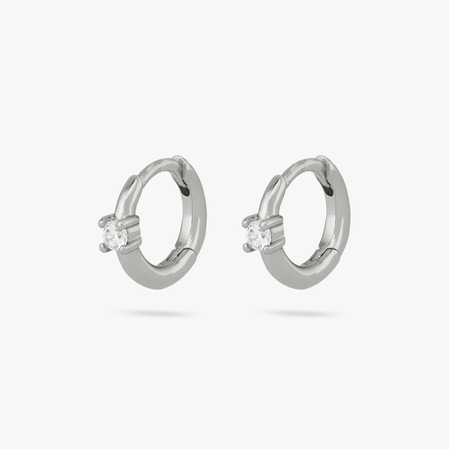 This is a pair of small silver huggies with clear cz details [pair] color:null|silver/clear