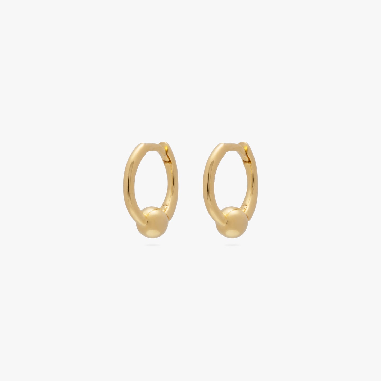 A pair of mini gold huggies with a small gold ball [pair] color:null|gold