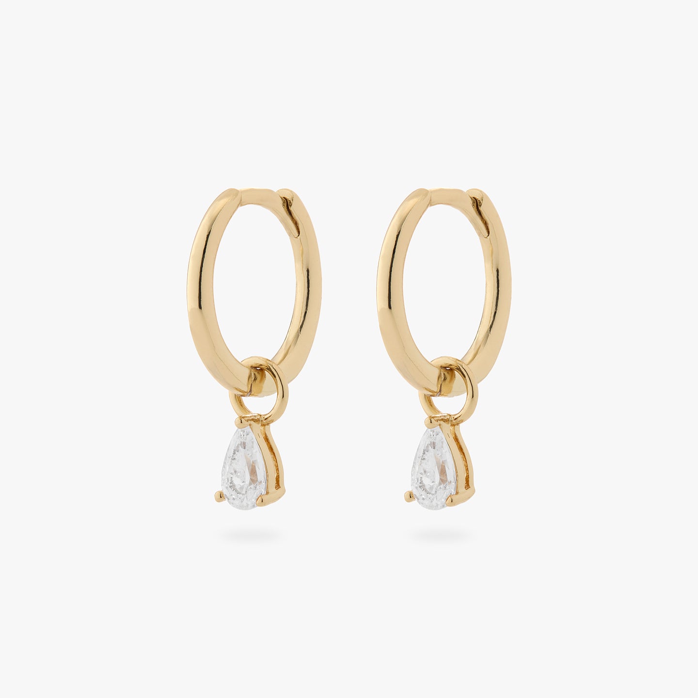a pair of gold small slim huggies with pear shaped clear cz charms [pair] color:null|gold/clear