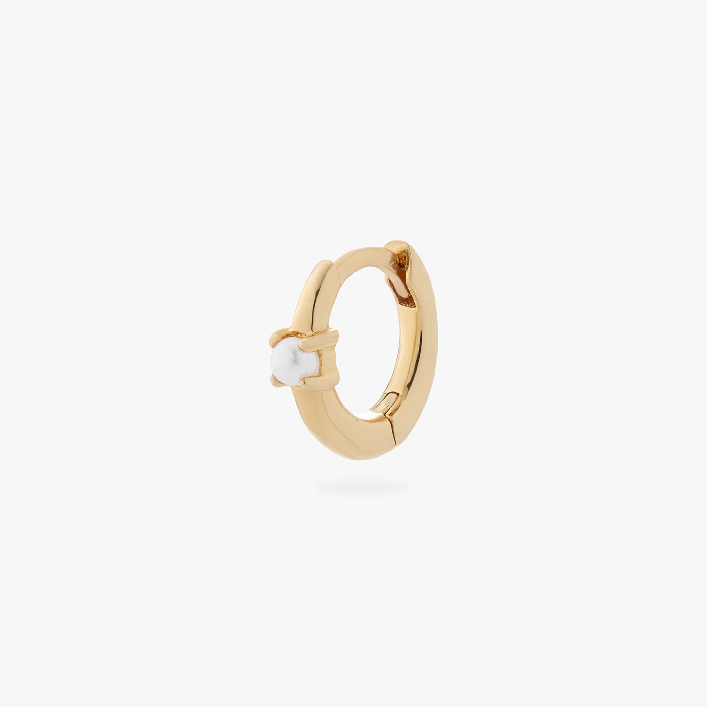a gold small huggie with a pearl accent stone color:null|gold
