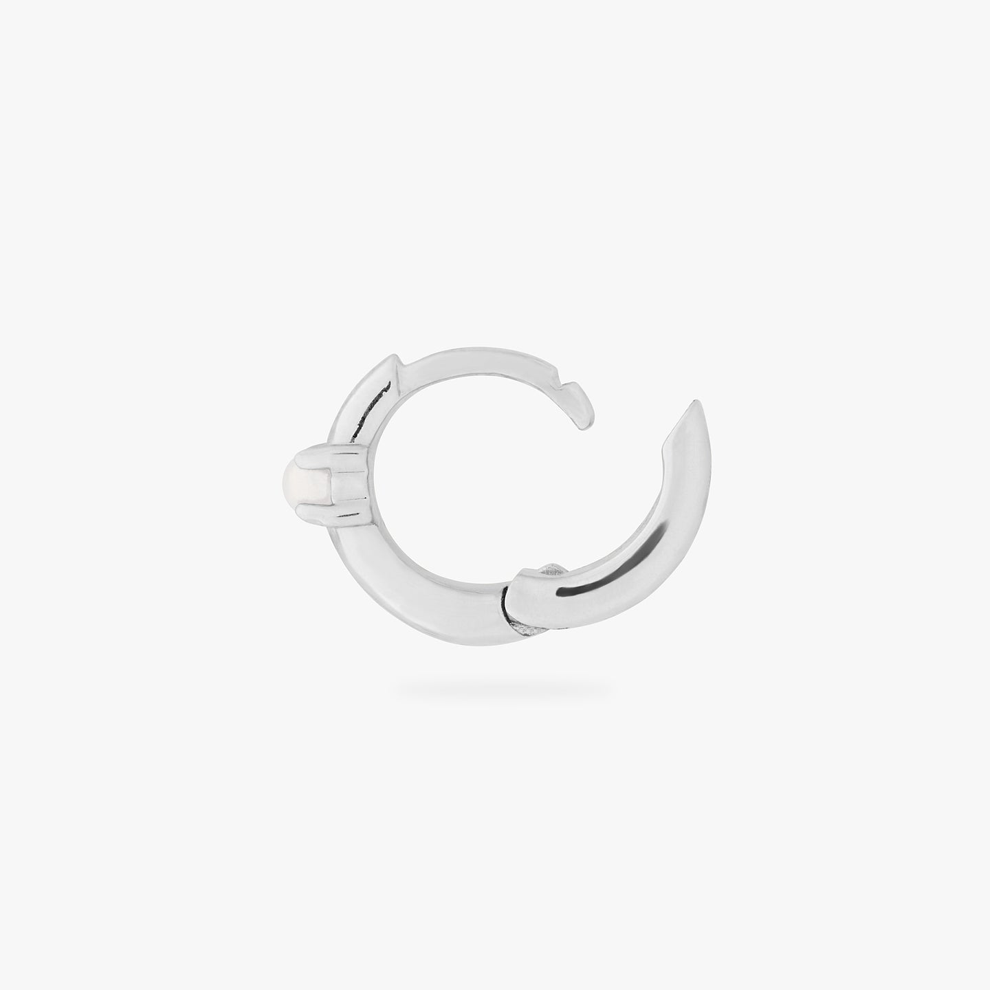 a silver small huggie with a pearl accent stone unhinged color:null|silver