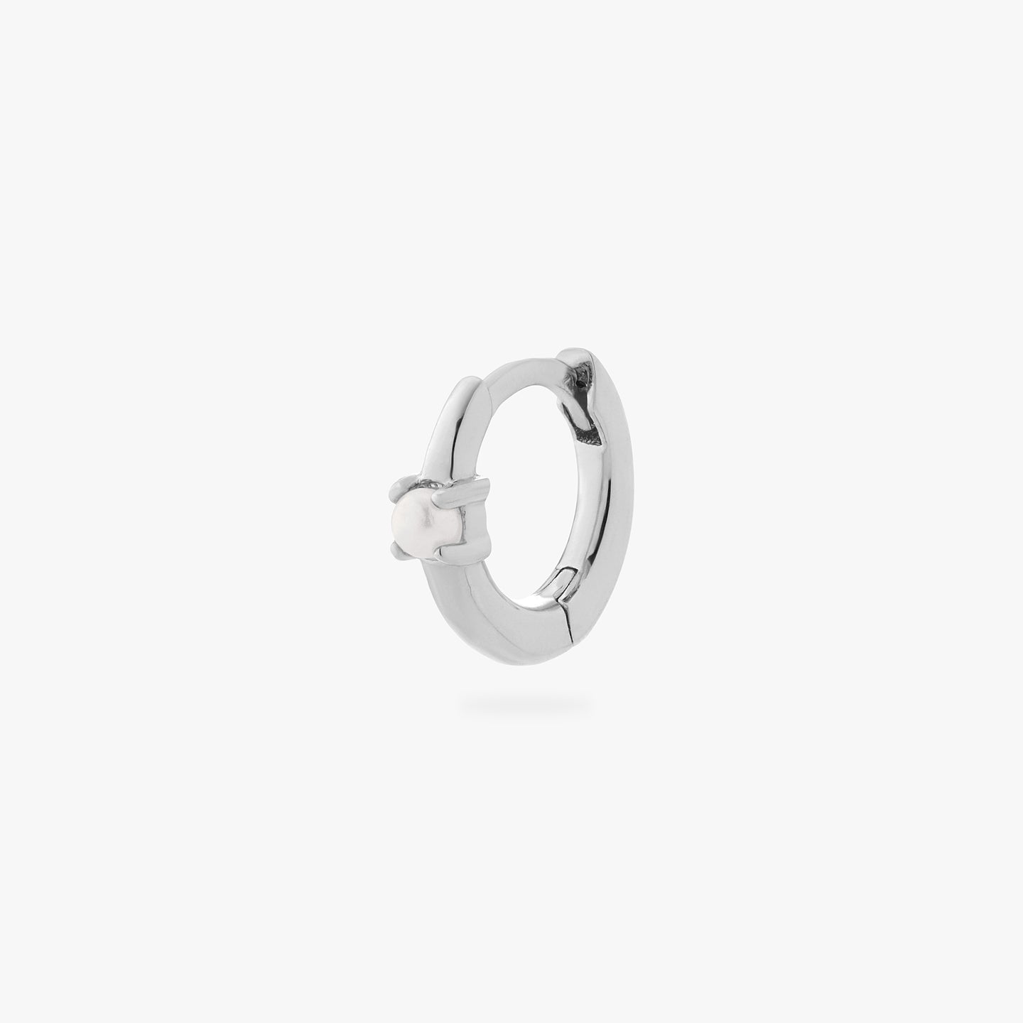 a silver small huggie with a pearl accent stone color:null|silver