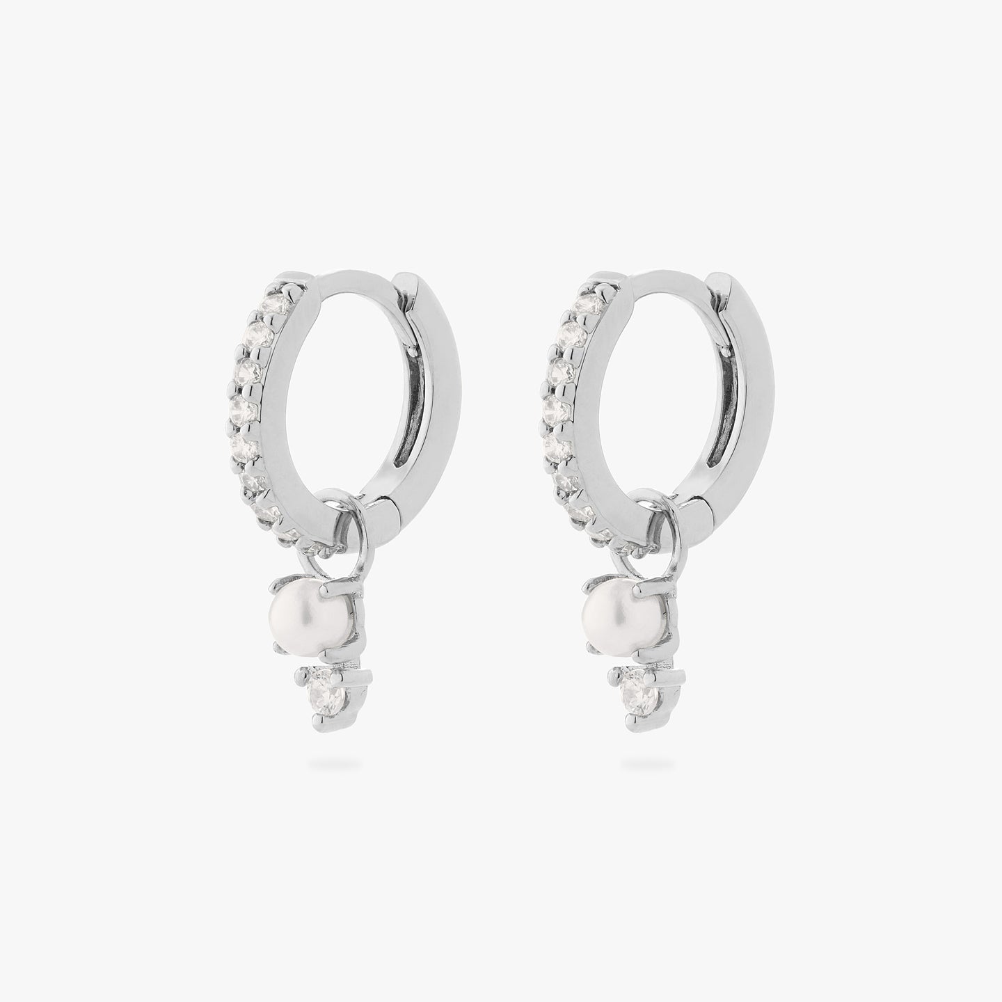 a pair of mini pave huggies in silver/clear with charms that have a stacked pearl and clear cz [pair] color:null|silver/pearl