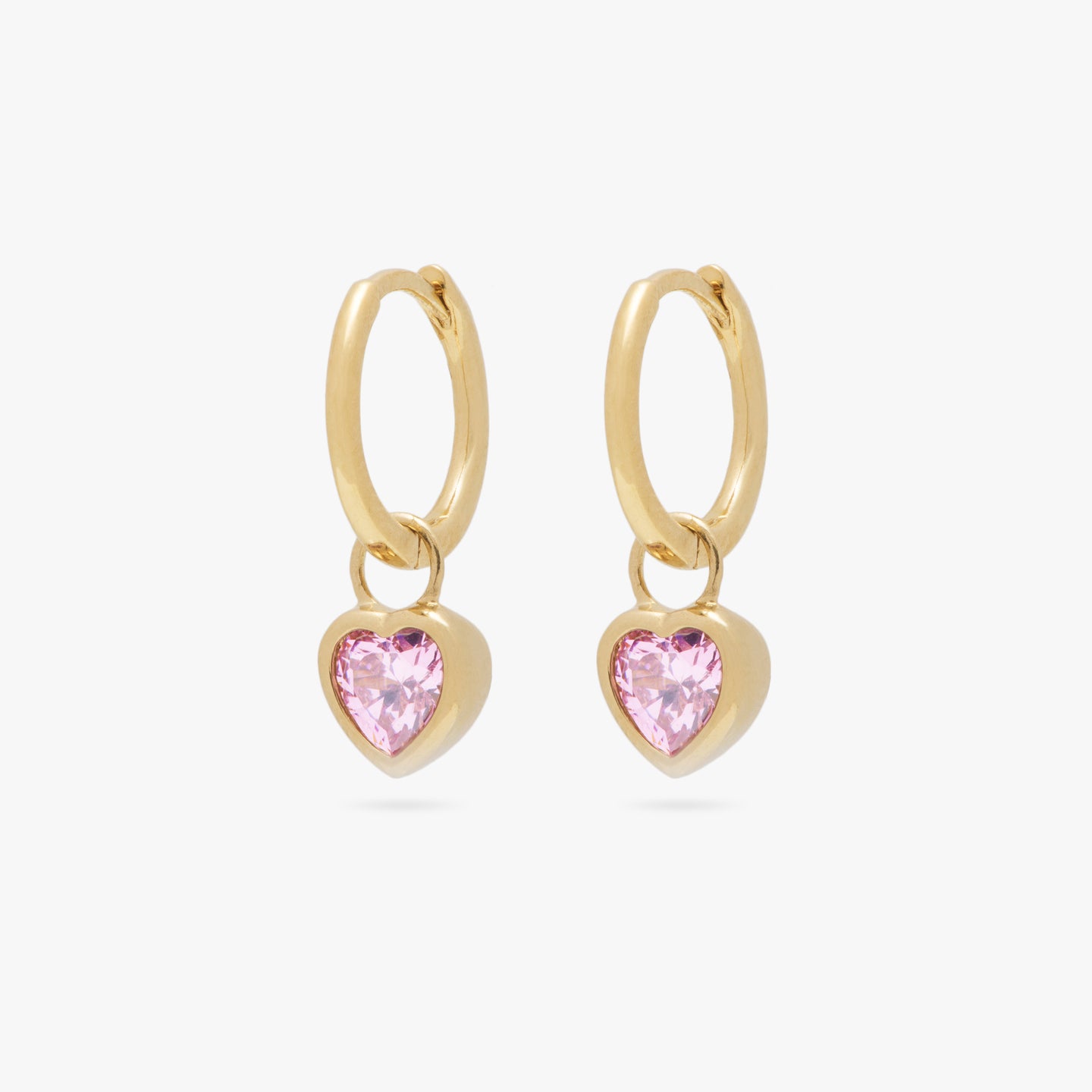 a pair of gold heart shaped charms on gold small slim huggies with pink cz stones [pair] color:null|gold/pink