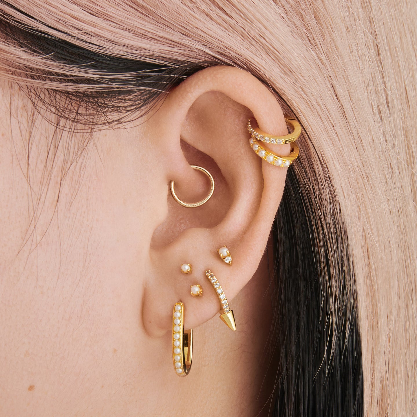 a medium oval hoop in gold with pearl settings on ear [hover] color:null|gold