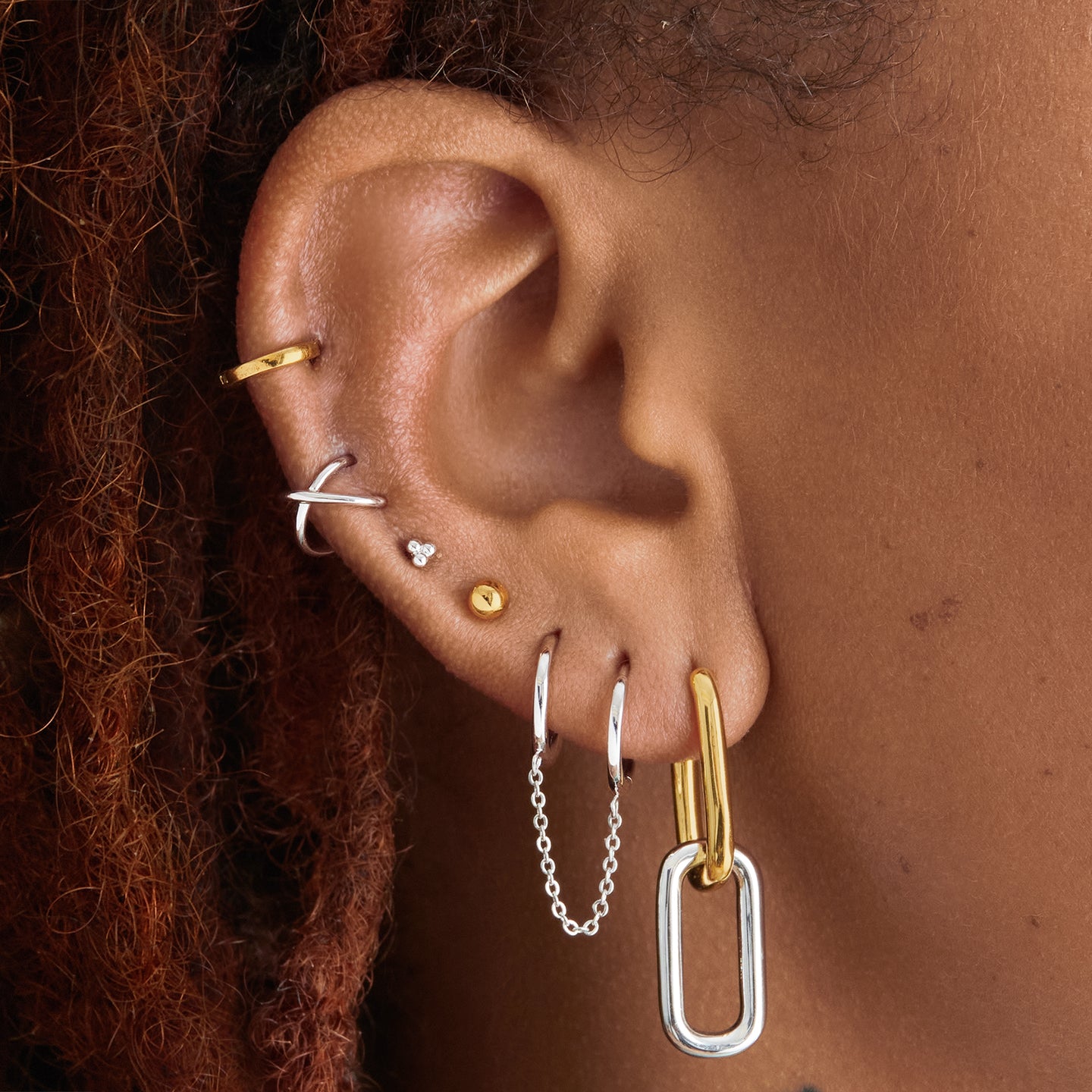 Two tone linked oval hoops with one gold hoop and one silver hoop color:null|gold/silver