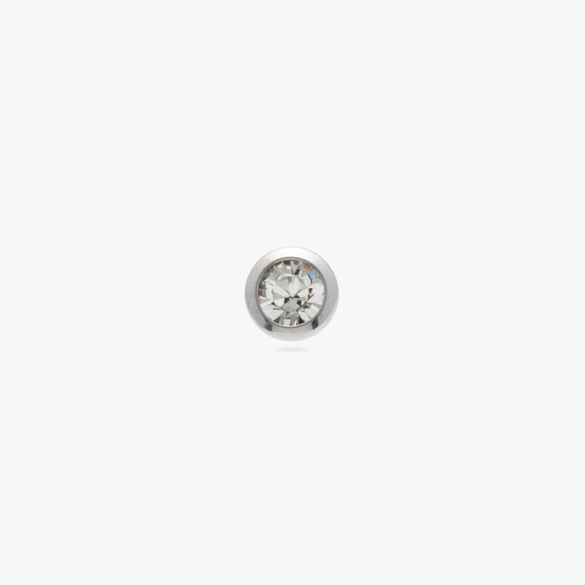 This image is a silver toned titanium flatback stud with a bezel setting and clear CZ stone against a white background.