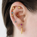 This image shows an ear with the 14k gold Paisley flatback stud 