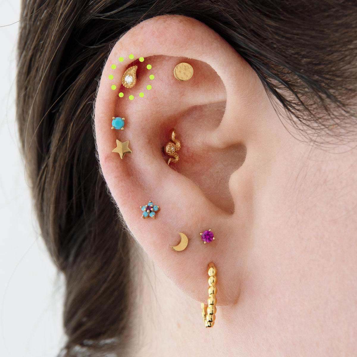 This image shows an ear with the 14k gold Paisley flatback stud 