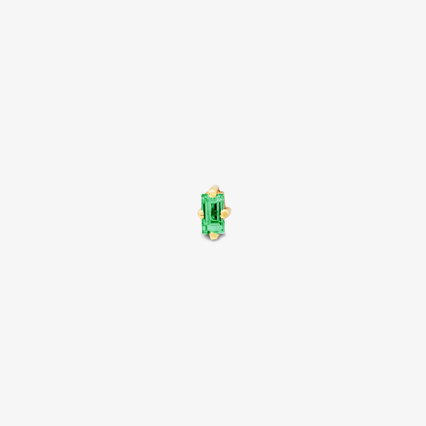 This is a small 18k gold stud with a square cut emerald color:18k gold/emerald